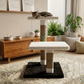 Cat resting on two-tier cat tree in bright bedroom